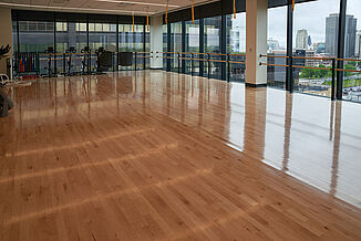 Hardwood Flooring in Multipurpose Corporate Wellness Center Room A section of the fitness center featuring hardwood flooring, providing a warm and inviting ambiance.