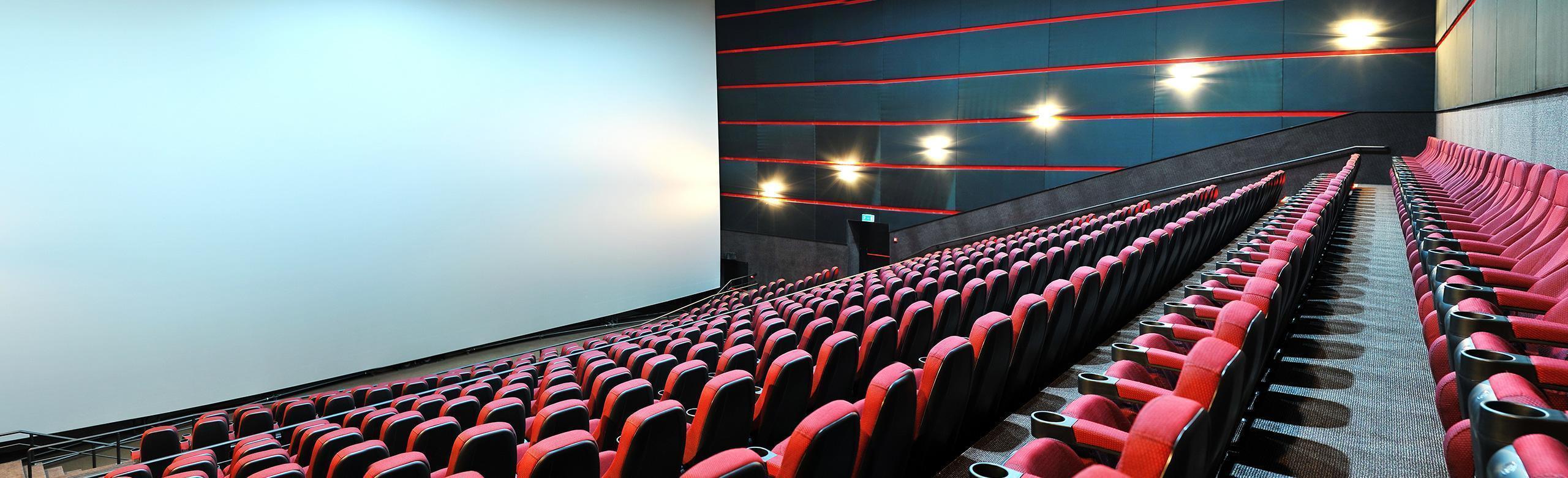 A movie theatering with rows of seats for the audience. The theater features REGUPOL acoustics.Create a comfortable, distraction-free environment in theaters and cinemas with REGUPOL acoustics.