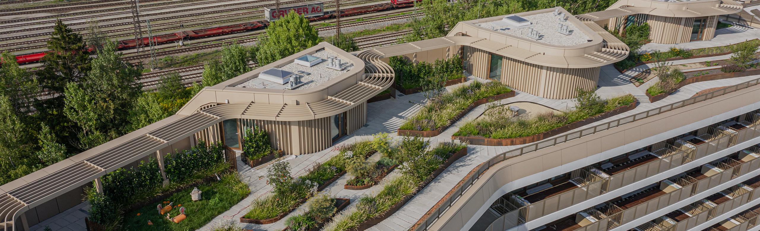 REGUPOL sound and drain - Rooftop Aerial view of the roof of a building located near train tracks. The space utilizes REGUPOL sound and drain installation to improve the acoustics of the rooftop terrace.