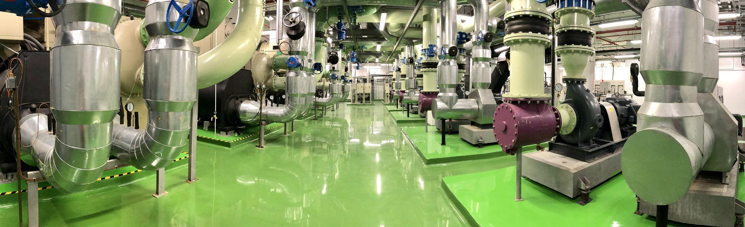 A large technical centre with lots of machine space on a green industrial floor.